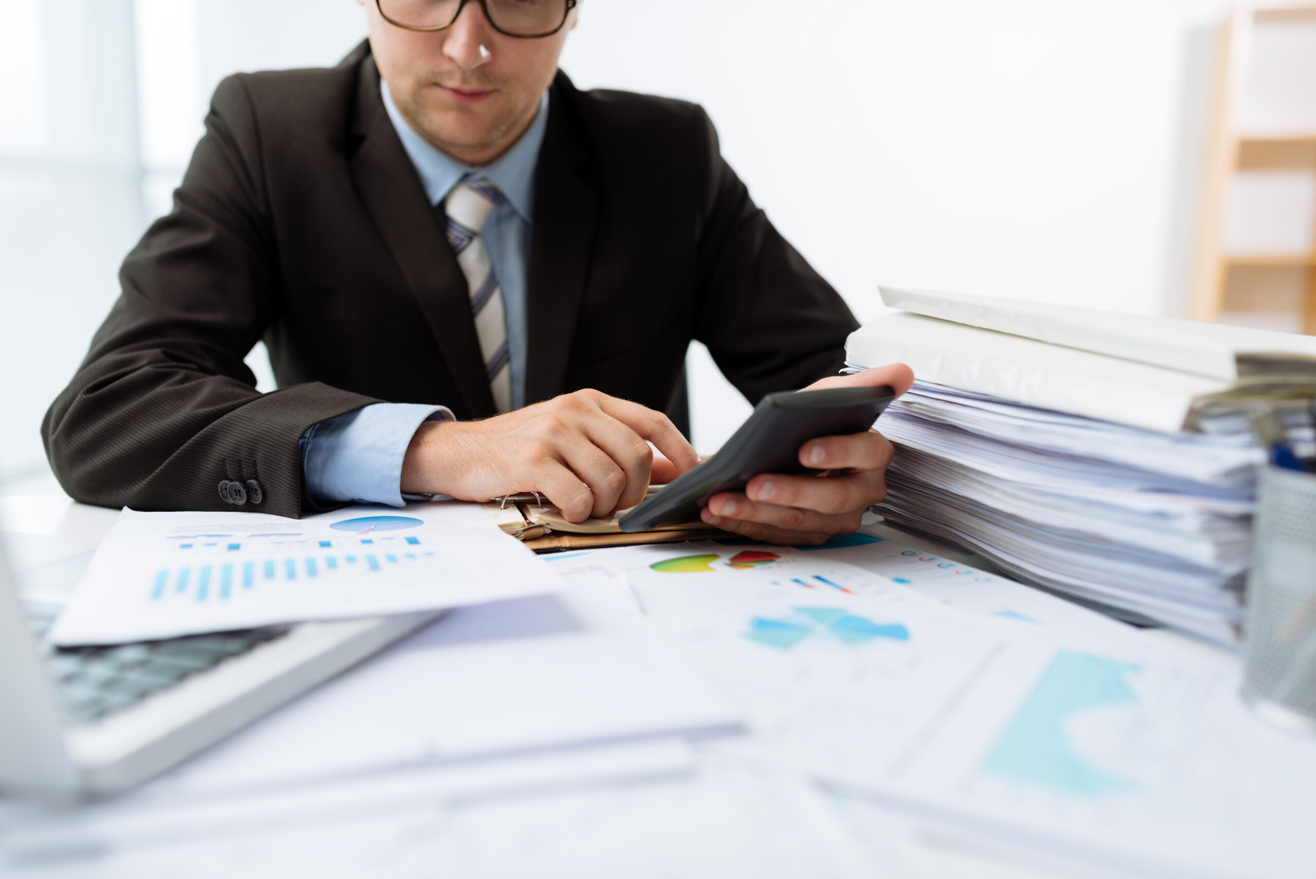 Cropped image of male accountant working with papers