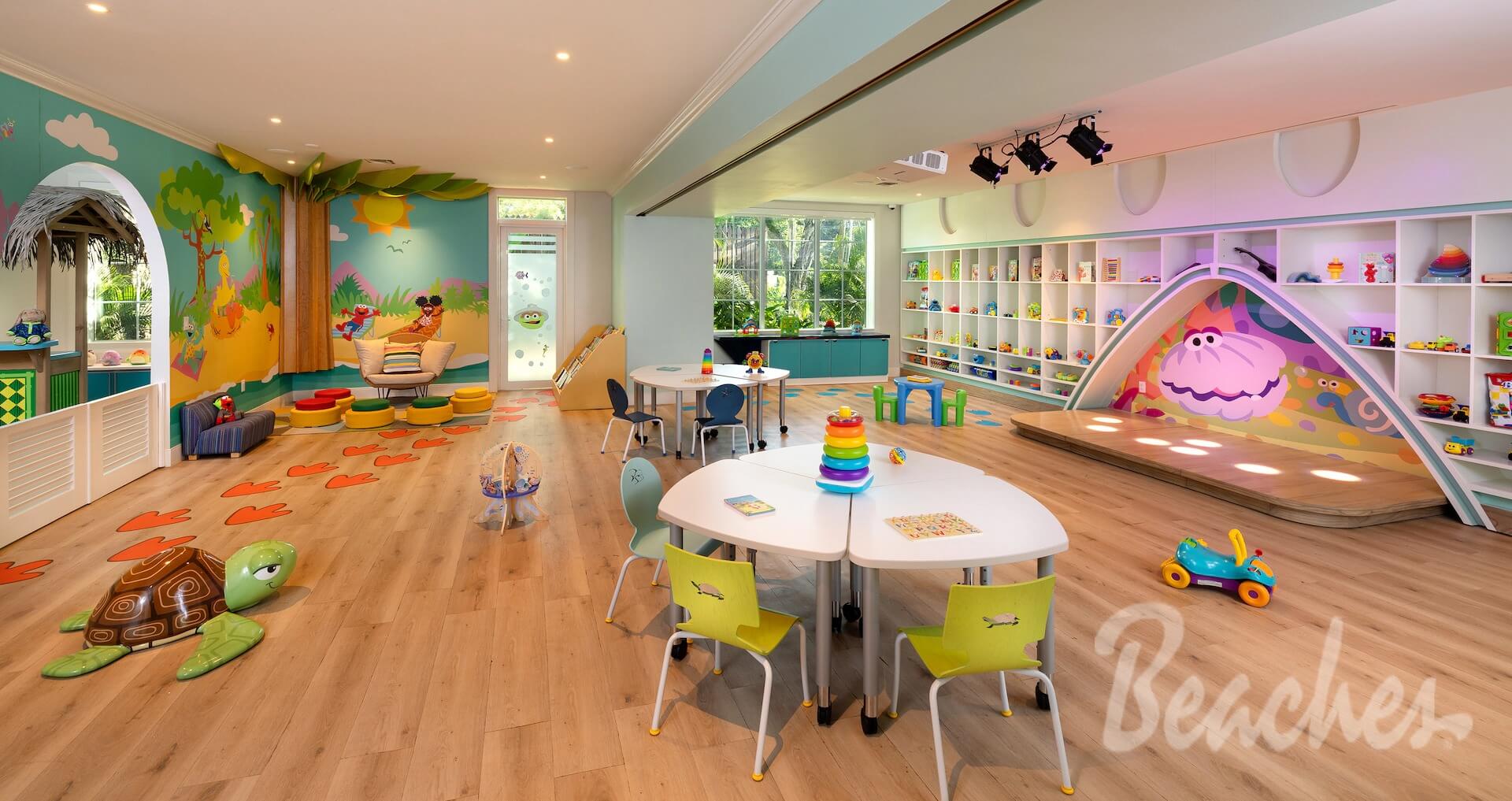 Beaches kids club playroom with colorful Sesame Street murals, toys, and child-size tables